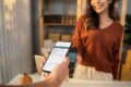 Person scannt einen QR-Code und beantwortet eine digitale Kundenbefragung per Smartphone 